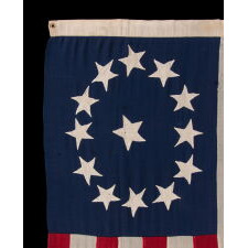ENTIRELY HAND-SEWN ANTIQUE AMERICAN FLAG OF THE CIVIL WAR PERIOD, WITH 13 SINGLE-APPLIQUED STARS IN A BEAUTIFUL, OVAL ARRANGEMENT OF WHAT IS KNOWN AS THE 3RD MARYLAND PATTERN, MADE SOMETIME BETWEEN THE 1850’s AND THE CIVIL WAR (1861-65)