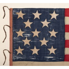 ENTIRELY HAND-SEWN ANTIQUE AMERICAN FLAG OF THE CIVIL WAR ERA, WITH 13 SINGLE-APPLIQUÉD STARS IN A 3-2-3-2-3 CONFIGURATION, IN A GREAT, SMALL SCALE AMONG ITS COUNTERPARTS, PROBABLY MADE IN NEW YORK CITY, SIGNED “GRÜNFILD”