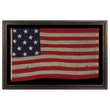 ENTIRELY HAND-SEWN, 13 STAR AMERICAN FLAG, WITH A 3-2-3-2-3 ARRANGEMENT OF STARS, U.S. NAVY SMALL BOAT ENSIGN, LIKELY MADE DURING THE CLOSING YEARS OF THE CIVIL WAR, 1864-1865