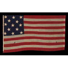 ENTIRELY HAND-SEWN, 13 STAR AMERICAN FLAG, WITH A 3-2-3-2-3 ARRANGEMENT OF STARS, U.S. NAVY SMALL BOAT ENSIGN, LIKELY MADE DURING THE CLOSING YEARS OF THE CIVIL WAR, 1864-1865