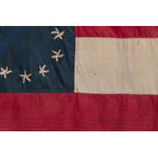 CONFEDERATE BIBLE FLAG IN THE FIRST NATIONAL FORMAT WITH 11 STARS IN A SINGLE WREATH, MADE OF SILK, PROBABLY TAKEN BY A UNION NAVY MAN DURING THE SIEGE OF VICKSBURG WHILE PILOTING THE U.S.S. LILY, A STEAMER TUG CONSCRIPTED INTO SERVICE BY THE U.S. ARMY, FITTED WITH GUNS, TRANSFERRED TO THE NAVY, AND SUNK AFTER COLLIDING WITH THE U.S.S. CHOCTAW, A UNION, IRONCLAD RAM