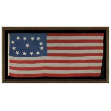 EARLY 13 STAR SHIP'S FLAG WITH AN EXCEPTIONAL, LOPSIDED OVAL VARIATION OF THE 3RD MARYLAND PATTERN, CA 1840-1860, AN ENTIRELY HAND-SEWN EXAMPLE WITH BEAUTIFUL FOLK QUALITIES, ONCE BELONGING TO THE LINSLEY & GAY FAMILIES OF CONNECTICUT AND MASSACHUSETTS