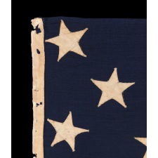 ENTIRELY HAND-SEWN, 13 STAR AMERICAN FLAG, WITH A 3-2-3-2-3 ARRANGEMENT OF STARS, U.S. NAVY SMALL BOAT ENSIGN, LIKELY MADE DURING THE CLOSING YEARS OF THE CIVIL WAR, 1864-1865