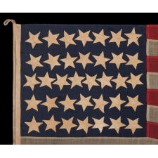 ENTIRELY HAND-SEWN, CIVIL WAR ERA, ANTIQUE AMERICAN FLAG OF THE CIVIL WAR ERA, WITH HAND-SEWN STARS, ENDEARING WEAR FROM LONG-TERM USE, AND ABSOLUTELY BEAUTIFUL PRESENTATION, REFLECTS NEVADA STATEHOOD, 1864-1867