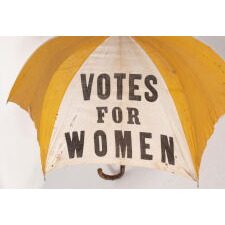 EXTRAORDINARILY RARE, YELLOW & WHITE, SUFFRAGE PARASOL / UMBRELLA, WITH “VOTES FOR WOMEN” TEXT, DISTRIBUTED BY THE NATIONAL AMERICAN WOMEN’S SUFFRAGE ASSOCIATION UNDER ANNA HOWARD SHAW’S LEADERSHIP [HEADQUARTERED IN NEW YORK], CIRCA 1913-1915