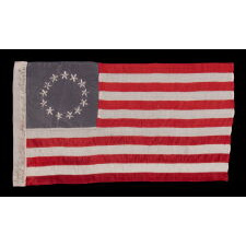 13 HAND-EMBROIDERED STARS AND EXPERTLY HAND-SEWN STRIPES ON AN ANTIQUE AMERICAN FLAG MADE IN PHILADELPHIA BY SARAH M. WILSON, GREAT-GRANDDAUGHTER OF BETSY ROSS, SIGNED & DATED 1911