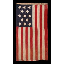 13 HAND-SEWN STARS IN A 3-2-3-2-3 PATTERN ON AN ANTIQUE AMERICAN FLAG, A U.S. NAVY SMALL BOAT ENSIGN MADE AT MARE ISLAND, CALIFORNIA, HEADQUARTERS OF THE PACIFIC FLEET, SIGNED & DATED 1902
