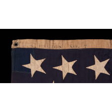13 HAND-SEWN STARS IN A 3-2-3-2-3 PATTERN ON AN ANTIQUE AMERICAN FLAG, A U.S. NAVY SMALL BOAT ENSIGN MADE AT MARE ISLAND, CALIFORNIA, HEADQUARTERS OF THE PACIFIC FLEET, SIGNED & DATED 1902
