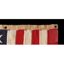 13 HAND-SEWN STARS IN A 3-2-3-2-3 PATTERN ON AN ANTIQUE AMERICAN FLAG, A U.S. NAVY SMALL BOAT ENSIGN MADE AT MARE ISLAND, CALIFORNIA, HEADQUARTERS OF THE PACIFIC FLEET, SIGNED & DATED 1902