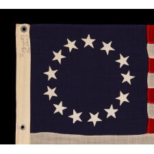 13 STARS IN THE BETSY ROSS PATTERN ON A SMALL-SCALE ANTIQUE AMERICAN FLAG MADE SOMETIME BETWEEN APPROXIMATELY 1910 AND THE 1926 SESQUICENTENNIAL OF AMERICAN INDEPENDENCE