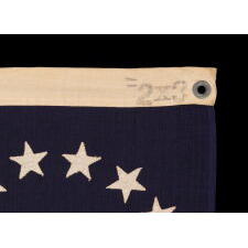 13 STARS IN THE BETSY ROSS PATTERN ON A SMALL-SCALE ANTIQUE AMERICAN FLAG MADE SOMETIME BETWEEN APPROXIMATELY 1910 AND THE 1926 SESQUICENTENNIAL OF AMERICAN INDEPENDENCE