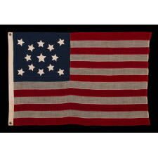 13 STARS IN A MEDALLION CONFIGURATION ON AN ANTIQUE AMERICAN FLAG WITH A MEDALLION CONFIGURATION OF 13 STARS, A SMALL-SCALE EXAMPLE MADE DURING THE LAST DECADE OF THE 19th CENTURY