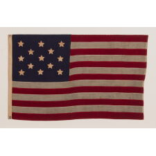 13 STARS WITH SHORT, CONICAL ARMS ON A SMALL SCALE, ANTIQUE AMERICAN FLAG MADE DURING THE LAST DECADE F THE 19TH CENTURY; POSSIBLY OF PHILADELPHIA ORIGIN; FORMERLY IN THE COLLECTION OF BOLESLAW & MARIE D'OTRANGE MASTAI, THE FIRST MAJOR COLLECTORS TO PUBLISH A PICTORIAL REFERENCE (KNOPF, NEW YORK, 1973):
