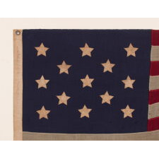13 STARS WITH SHORT, CONICAL ARMS ON A SMALL SCALE, ANTIQUE AMERICAN FLAG MADE DURING THE LAST DECADE F THE 19TH CENTURY; POSSIBLY OF PHILADELPHIA ORIGIN; FORMERLY IN THE COLLECTION OF BOLESLAW & MARIE D'OTRANGE MASTAI, THE FIRST MAJOR COLLECTORS TO PUBLISH A PICTORIAL REFERENCE (KNOPF, NEW YORK, 1973):