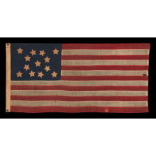 13 STARS WITH SHORT, CONICAL ARMS ON A SMALL SCALE, ANTIQUE AMERICAN FLAG WITH A BEAUTIFULLY ELONGATED FORMAT AND MUCH PATINA FROM OBVIOUS USE; MADE DURING THE LAST DECADE OF THE 19th CENTURY, POSSIBLY BY J.S. OBERHOLTZER IN GERMANTOWN [PHILADELPHIA], PENNSYLVANIA