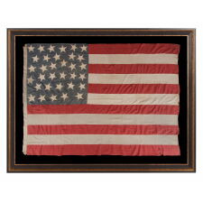 33 HAPHAZARDLY PLACED STARS AND 11 STRIPES ON AN ANTIQUE AMERICAN FLAG WITH ITS CANTON RESTING ON THE WAR STRIPE, POSSIBLY MADE WITH SOUTHERN SYMPATHIES; REFLECTS THE ADDITION OF OREGON TO THE UNION ON VALENTINES DAY, 1859; OFFICIAL FROM JULY 4th OF THAT YEAR UNTIL JULY 3rd, 1861