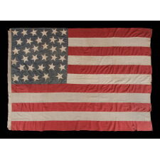 33 HAPHAZARDLY PLACED STARS AND 11 STRIPES ON AN ANTIQUE AMERICAN FLAG WITH ITS CANTON RESTING ON THE WAR STRIPE, POSSIBLY MADE WITH SOUTHERN SYMPATHIES; REFLECTS THE ADDITION OF OREGON TO THE UNION ON VALENTINE’S DAY, 1859; OFFICIAL FROM JULY 4th OF THAT YEAR - JULY 3rd, 1861