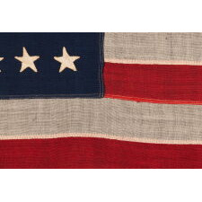 38 HAND-SEWN STARS ON AN ANTIQUE AMERICAN FLAG IN AN EXTRAORDINARILY TINY SCALE AMONG ITS PIECED-AND-SEWN COUNTERPARTS, MADE AT THE TIME WHEN COLORADO WAS THE MOST RECENT STATE TO JOIN THE UNION, 1876-1889; PROBABLY MADE BY THE ANNIN COMPANY IN NEW YORK CITY, SIGNED BY MEMBERS OF THE GRIMES & JOHNSON FAMILIES OF CANANDAIGUA, NEW YORK
