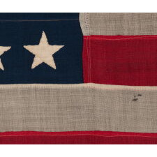 38 HAND-SEWN STARS IN A "NOTCHED" PATTERN, ON AN ANTIQUE AMERICAN FLAG WITH BEAUTIFUL WEAR FROM HAVING BEEN EXTENSIVELY FLOWN, MADE AT THE TIME WHEN COLORADO WAS THE MOST RECENT STATE TO JOIN THE UNION, 1876-1889