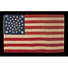 38 STARS, COLORADO STATEHOOD, A SCARCE AND BEAUTIFUL ANTIQUE AMERICAN FLAG WITH A MEDALLION PATTERN AND 4 LARGE CORNER STARS, PRESS-DYED ON WOOL BUNTING, MADE BY HORSTMANN BROTHERS IN PHILADELPHIA FOR THE 1876 CENTENNIAL OF OUR NATION’S INDEPENDENCE