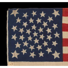 38 STARS, COLORADO STATEHOOD, A SCARCE AND BEAUTIFUL ANTIQUE AMERICAN FLAG WITH A MEDALLION PATTERN AND 4 LARGE CORNER STARS, PRESS-DYED ON WOOL BUNTING, MADE BY HORSTMANN BROTHERS IN PHILADELPHIA FOR THE 1876 CENTENNIAL OF OUR NATION’S INDEPENDENCE