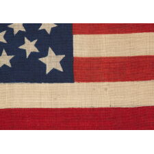 38 STARS, COLORADO STATEHOOD, A SCARCE AND BEAUTIFUL ANTIQUE AMERICAN FLAG WITH A MEDALLION PATTERN AND 4 LARGE CORNER STARS, PRESS-DYED ON WOOL BUNTING, MADE BY HORSTMANN BROTHERS IN PHILADELPHIA FOR THE 1876 CENTENNIAL OF OUR NATION’S INDEPENDENCE