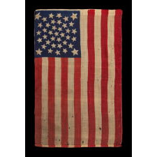 38 STARS, COLORADO STATEHOOD, A SCARCE AND BEAUTIFUL ANTIQUE AMERICAN FLAG WITH A MEDALLION PATTERN AND 4 LARGE CORNER STARS, PRESS-DYED ON WOOL BUNTING, MADE BY HORSTMANN BROTHERS IN PHILADELPHIA FOR THE 1876 CENTENNIAL OF OUR NATION’S INDEPENDENCE