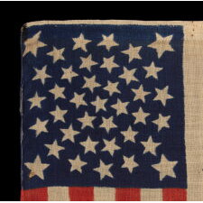 38 STARS, COLORADO STATEHOOD, A SCARCE AND BEAUTIFUL ANTIQUE AMERICAN FLAG WITH A MEDALLION PATTERN AND 4 LARGE CORNER STARS, PRESS-DYED ON WOOL BUNTING, MADE BY HORSTMANN BROTHERS IN PHILADELPHIA FOR THE 1876 CENTENNIAL OF OUR NATION’S INDEPENDENCE