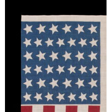 39 STARS IN TWO SIZES, ALTERNATING FROM ONE COLUMN TO THE NEXT, ON AN ANTIQUE AMERICAN PARADE FLAG DATING TO THE 1876 CENTENNIAL, NEVER AN OFFICIAL STAR COUNT, REFLECTS THE ANTICIPATED ARRIVAL OF COLORADO AND THE DAKOTA TERRITORY