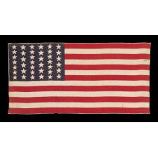 39 STARS IN TWO SIZES, ALTERNATING FROM ONE COLUMN TO THE NEXT, ON AN ANTIQUE AMERICAN PARADE FLAG WITH AN UNUSUALLY ELONGATED PROFILE, DATING TO THE 1876 CENTENNIAL, NEVER AN OFFICIAL STAR COUNT, REFLECTS THE ANTICIPATED ARRIVAL OF COLORADO AND THE DAKOTA