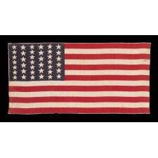 39 STARS IN TWO SIZES, ALTERNATING FROM ONE COLUMN TO THE NEXT, ON AN ANTIQUE AMERICAN PARADE FLAG WITH AN UNUSUALLY ELONGATED PROFILE, DATING TO THE 1876 CENTENNIAL, NEVER AN OFFICIAL STAR COUNT, REFLECTS THE ANTICIPATED ARRIVAL OF COLORADO AND THE DAKOTA
