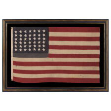 42 HAND-SEWN STARS ON AN ANTIQUE AMERICAN FLAG WITH A TWO-TONE, DUSTY BLUE CANTON, REFLECTS THE ADDITION OF WASHINGTON STATE, MONTANA, AND THE DAKOTAS, NEVER AN OFFICIAL STAR COUNT, circa 1889-1890