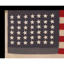 42 HAND-SEWN STARS ON AN ANTIQUE AMERICAN FLAG WITH A TWO-TONE, DUSTY BLUE CANTON, REFLECTS THE ADDITION OF WASHINGTON STATE, MONTANA, AND THE DAKOTAS, NEVER AN OFFICIAL STAR COUNT, circa 1889-1890