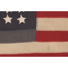 42 HAND-SEWN STARS ON AN ANTIQUE AMERICAN FLAG WITH A TWO-TONE, DUSTY BLUE CANTON, REFLECTS THE ADDITION OF WASHINGTON STATE, MONTANA, AND THE DAKOTAS, NEVER AN OFFICIAL STAR COUNT, circa 1889-1890