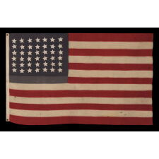 42 HAND-SEWN STARS ON AN ANTIQUE AMERICAN FLAG WITH A TWO-TONE, DUSTY BLUE CANTON, REFLECTS THE ADDITION OF WASHINGTON STATE, MONTANA, AND THE DAKOTAS, NEVER AN OFFICIAL STAR COUNT, circa 1889-1890