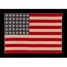 42 STARS ON AN ANTIQUE AMERICAN FLAG WITH SCATTERED STAR POSITIONING, REFLECTS THE ADDITION OF WASHINGTON STATE, MONTANA, AND THE DAKOTAS, NEVER AN OFFICIAL STAR COUNT, circa 1889-1890