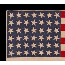 42 STARS ON AN ANTIQUE AMERICAN FLAG WITH SCATTERED STAR POSITIONING, REFLECTS THE ADDITION OF WASHINGTON STATE, MONTANA, AND THE DAKOTAS, NEVER AN OFFICIAL STAR COUNT, circa 1889-1890