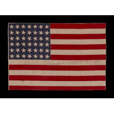 42 STARS ON AN ANTIQUE AMERICAN FLAG WITH SCATTERED STAR POSITIONING, REFLECTS THE ADDITION OF WASHINGTON STATE, MONTANA, AND THE DAKOTAS, NEVER AN OFFICIAL STAR COUNT, circa 1889-1890