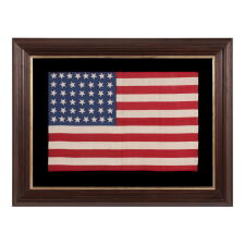 44 STARS IN JUSTIFIED ROWS, WITH VARIED STAR POSITIONING, ON A SILK, ANTIQUE AMERICAN FLAG WITH STRIKING COLORS, REFLECTS WYOMING STATEHOOD, circa 1890-1896