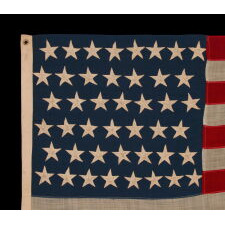 44 STARS IN ZIGZAGGING, STAGGERED ROWS, ON ANTIQUE AMERICAN FLAG WITH SOMEWHAT ELONGATED PROPORTIONS AND STRONG COLORS, MADE IN THE ERA WHEN WYOMING WAS THE MOST RECENT STATE TO JOIN THE UNION, 1890-1896