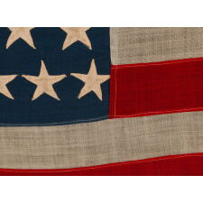 44 STARS IN ZIGZAGGING, STAGGERED ROWS, ON ANTIQUE AMERICAN FLAG WITH SOMEWHAT ELONGATED PROPORTIONS AND STRONG COLORS, MADE IN THE ERA WHEN WYOMING WAS THE MOST RECENT STATE TO JOIN THE UNION, 1890-1896