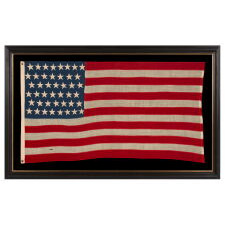 44 STARS IN ZIGZAGGING, STAGGERED ROWS, ON ANTIQUE AMERICAN FLAG WITH SOMEWHAT ELONGATED PROPORTIONS AND STRONG COLORS, MADE IN THE ERA WHEN WYOMING WAS THE MOST RECENT STATE TO JOIN THE UNION, 1890-1896