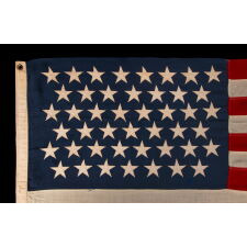 45 STARS ON AN ANTIQUE AMERICAN FLAG OF THE 1896-1908 ERA, REFLECTS THE ADDITION OF UTAH AS THE 45TH STATE; SPANISH-AMERICAN WAR ERA; AN ESPECIALLY BEAUTIFUL EXAMPLE WITH LARGER STARS THAN MOST AND EXCEPTIONAL, TRADITIONAL SHADES OF SCARLET RED AND NAVY