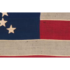 CIVIL WAR PERIOD ANTIQUE AMERICAN FLAG WITH 35 STARS IN A “GREAT STAR” OR “GREAT LUMINARY” PATTERN, A VERY RARE VARIETY WITH AN OPEN, LONE STAR PROFILE, LACKING STARS INSIDE OR BEYOND THE ARRANGEMENT; MADE circa 1863-65, REFLECTS THE ADMISSION OF WEST VIRGINIA TO THE UNION AS A FREE STATE, ANNEXED FROM VIRGINIA JUST 10 DAYS BEFORE THE BATTLE OF GETTYSBURG; PROBABLY WAR-CARRIED