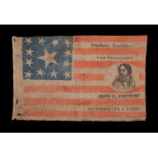 EXTRAORDINARILY RARE, PORTRAIT STYLE PARADE FLAG, MADE FOR THE PRESIDENTIAL CAMPAIGN OF JOHN FRÉMONT, WHO OPENED THE GATEWAY TO CALIFORNIA STATEHOOD, WAS THE REPUBLICAN PARTY’S FIRST PRESIDENTIAL CANDIDATE, AND RAN ON AN ANTI-SLAVERY PLATFORM; DISPLAYING 13 STARS, ARRANGED IN THE TRUMBULL PATTERN