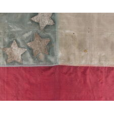 EXTRAORDINARY, HOMEMADE, 1ST CONFEDERATE NATIONAL FLAG, MADE OF LADIES’ DRESS SILK, WITH BEAUTIFUL COLORS AND EXCEPTIONAL PRESSED FOIL STARS, POSSIBLY OF NORTH CAROLINA ORIGIN; LIKELY PRESENTED TO AN OFFICER BY A LOVED ONE AND SEEMINGLY DISPLAYED THEREAFTER AS CONDITIONS PERMITTED; CAPTURED OR SEIZED BY CHAPLAIN-TURNED-GENERAL ELIPHALET WHITTLESEY OF MAINE, A STRONG OPPONENT OF SLAVERY, WHO EVENTUALLY LED AN ALL-BLACK REGIMENT (46TH U.S. COLORED TROOPS)