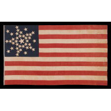 SPECTACULAR ANTIQUE AMERICAN FLAG WITH 38 STARS, ARRANGED IN A RARE VARIANT OF THE "GREAT STAR" PATTERN THAT INCORPORATES STARS BETWEEN EACH ARM; MADE FOR THE 100th ANNIVERSARY OF AMERICAN INDEPENDENCE IN 1876, AMONG THE VERY BEST OF ALL KNOWN EXAMPLES IN THIS STAR COUNT, REFLECTS THE ADDITION OF COLORADO AS THE “CENTENNIAL STATE”