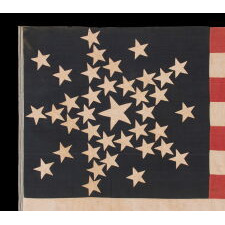 SPECTACULAR ANTIQUE AMERICAN FLAG WITH 38 STARS, ARRANGED IN A RARE VARIANT OF THE "GREAT STAR" PATTERN THAT INCORPORATES STARS BETWEEN EACH ARM; MADE FOR THE 100th ANNIVERSARY OF AMERICAN INDEPENDENCE IN 1876, AMONG THE VERY BEST OF ALL KNOWN EXAMPLES IN THIS STAR COUNT, REFLECTS THE ADDITION OF COLORADO AS THE “CENTENNIAL STATE”
