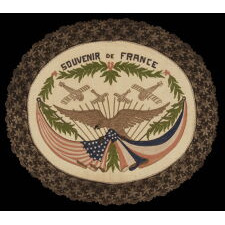 FRANCO-AMERICAN TEXTILE WITH THE IMAGE OF AN EAGLE SUPPORTING KNOTTED & DRAPED AMERICAN AND FRENCH FLAGS BENEATH FOUR WAR PLANES; RENDERED IN EMBROIDERED SILK FLOSS AND METALLIC BULLION ON SILK, MADE TO CELEBRATE THE END OF WWI