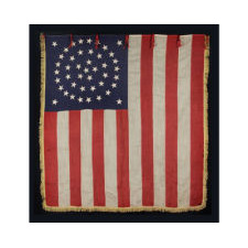 RARE AND EXCEPTIONAL 44 STAR UNITED STATES INFANTRY BATTLE FLAG WITH A MEDALLION CONFIGURATION, GOLD FRINGE, AND RED WOOL TIES, LATE INDIAN WARS, WYOMING STATEHOOD, 1890-1896